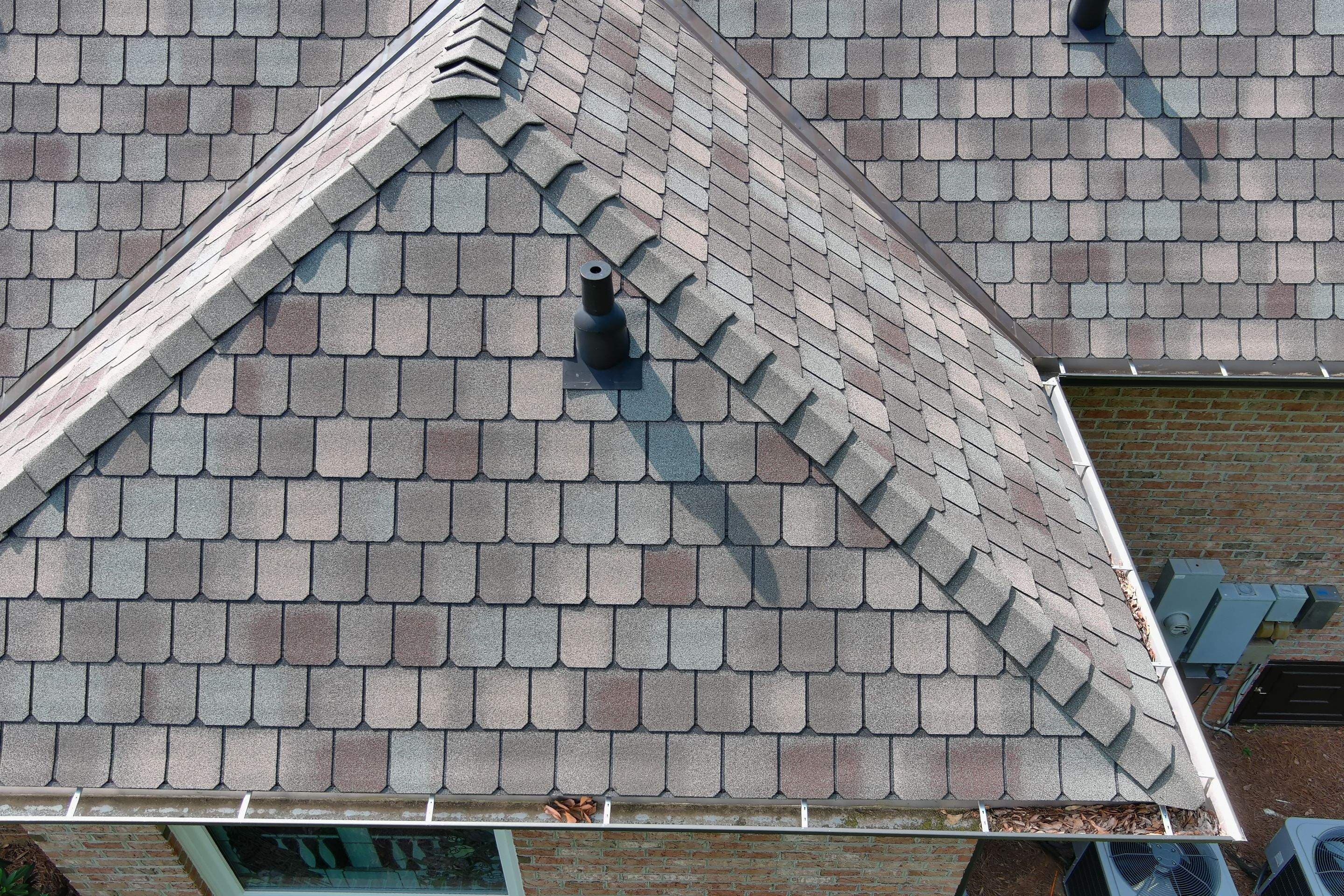 Shingle roof with pipe boot flashing and ridge cap details