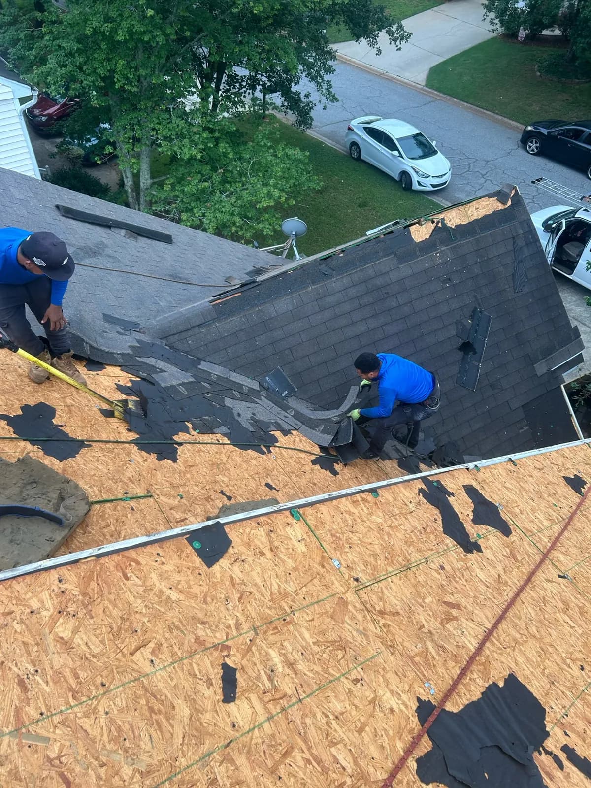 Roofers replacing damaged roof decking