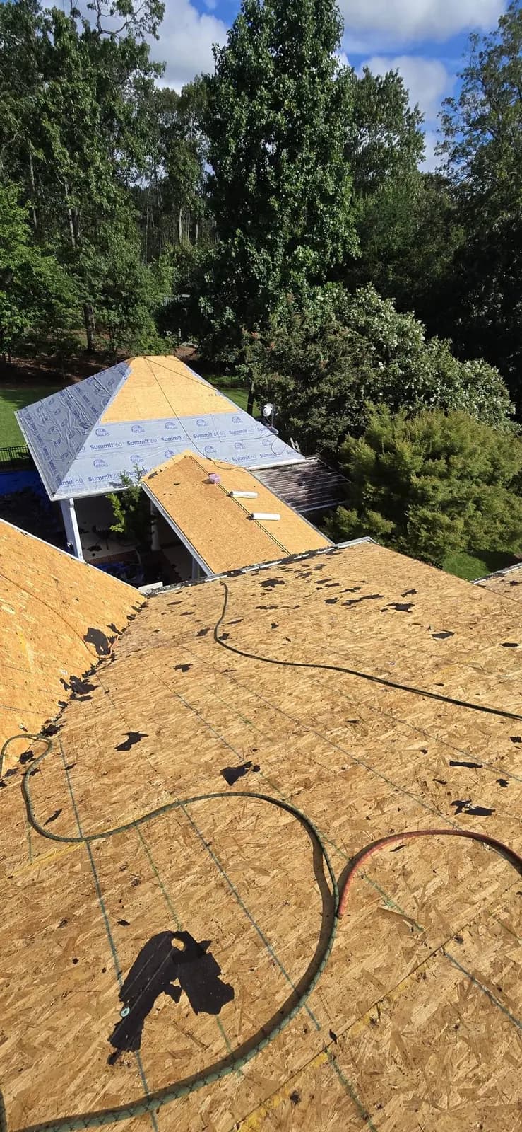 Roof underlayment being installed over new decking